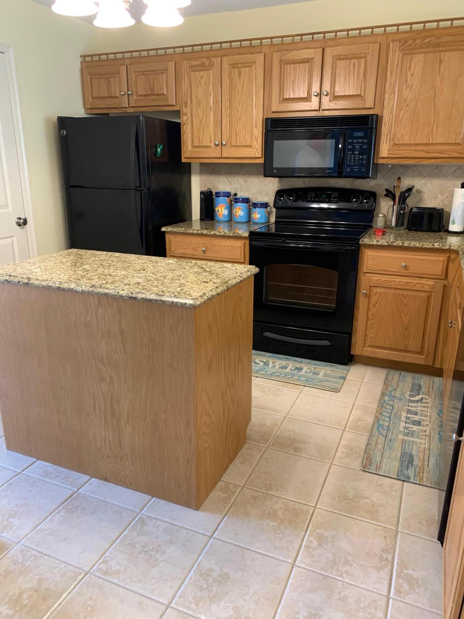 610 Monte Vista Road, Unit 706 Union Hall, VA 24176 - Photo 9 of 25 a kitchen with granite countertop a stove and a refrigerator