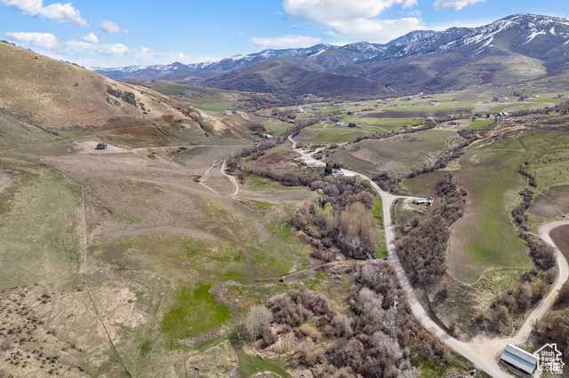 5337 East Maple Creek Road, Unit 1 Franklin, ID 83237 - Photo 8 of 28 Aerial view of property and surrounding area with a mountainous background and rural landscape
