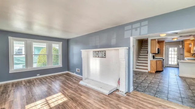a view of a room with wooden floor and windows