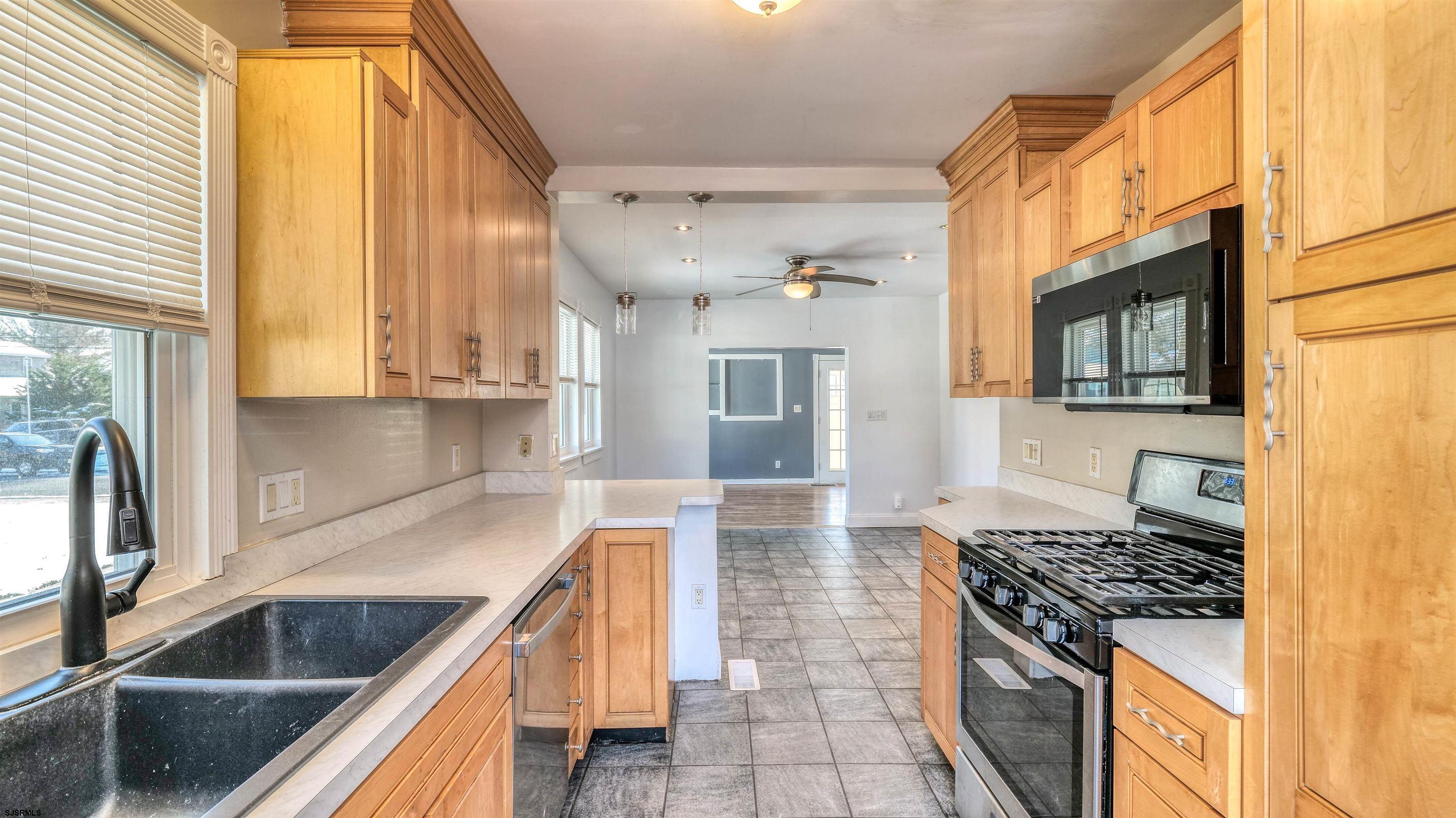 137 West Johnson Avenue Somers Point, NJ 08244 - Photo 16 of 33 a kitchen with stainless steel appliances granite countertop a sink and a stove