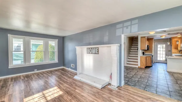 a view of a room with wooden floor and windows