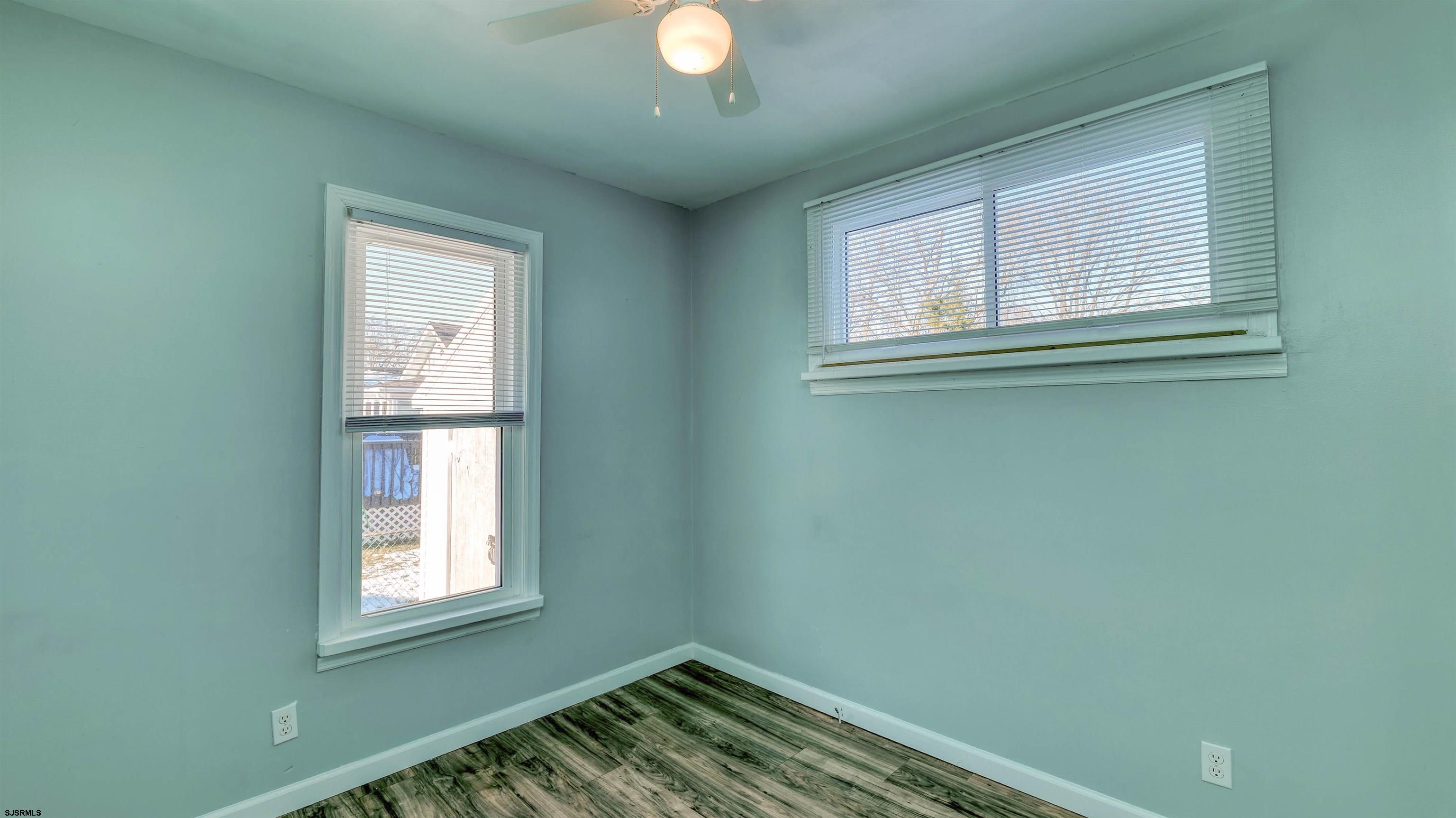 137 West Johnson Avenue Somers Point, NJ 08244 - Photo 20 of 33 an empty room with wooden floor and windows