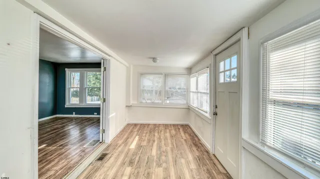 a view of a room with wooden floor and windows