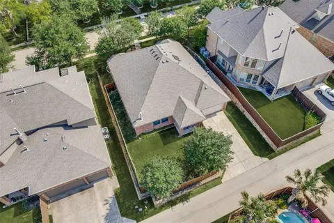 an aerial view of a house with a yard