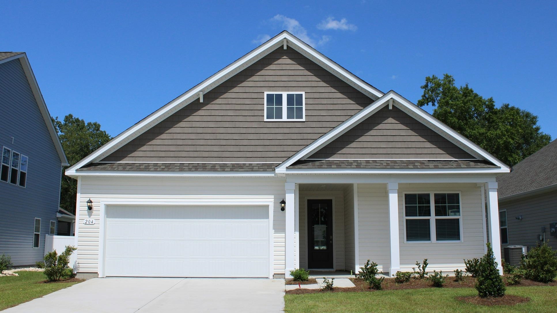 View of front of house with driveway, a porch, a shingled roof, and a front lawn