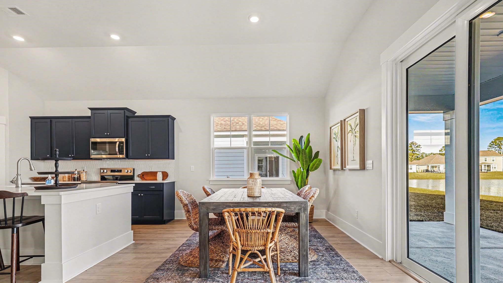 3250 Moss Bridge Lane Myrtle Beach, SC 29579 - Photo 7 of 29 Dining area featuring lofted ceiling, light wood-style flooring, recessed lighting, and a water view