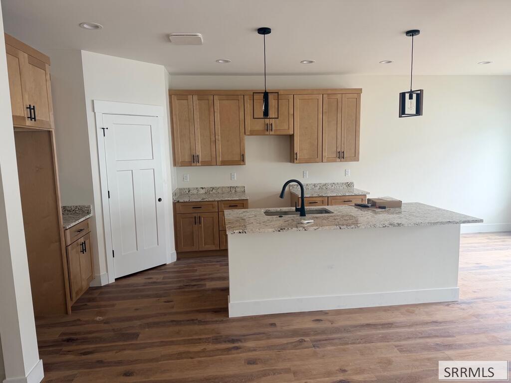 172 Kiana Avenue Rigby, ID 83442 - Photo 7 of 33 Warm Kitchen, Large Island-Bar to sit at. A lot of oversized wood cabinets.