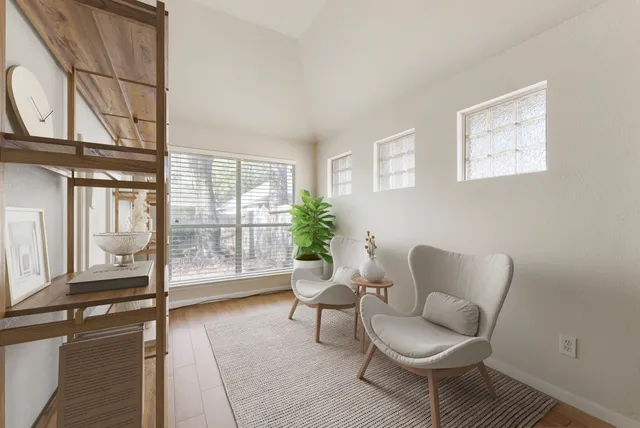 a bedroom with a bed lamp and a potted plant