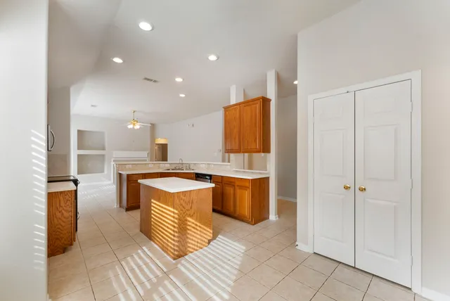 a living room with furniture and kitchen view
