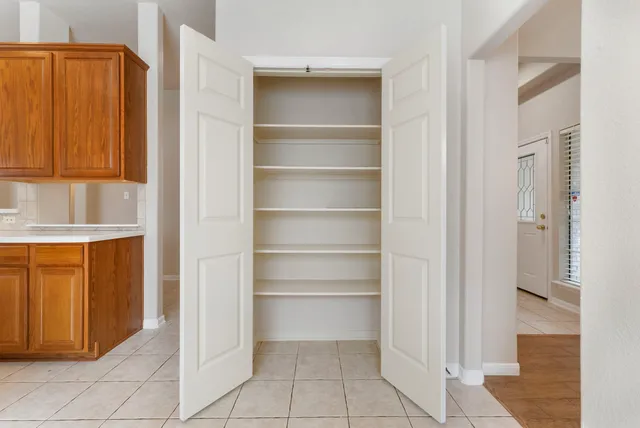 a view of a dining room with furniture and a window