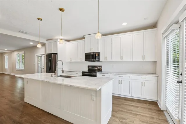 a bathroom with a granite countertop sink a large mirror and shower