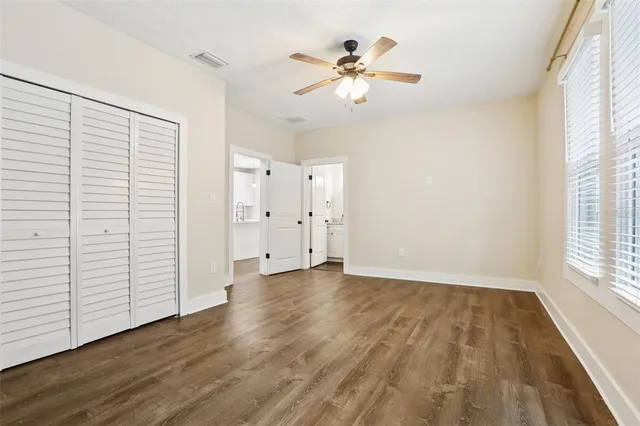 a bathroom with a granite countertop toilet sink and mirror