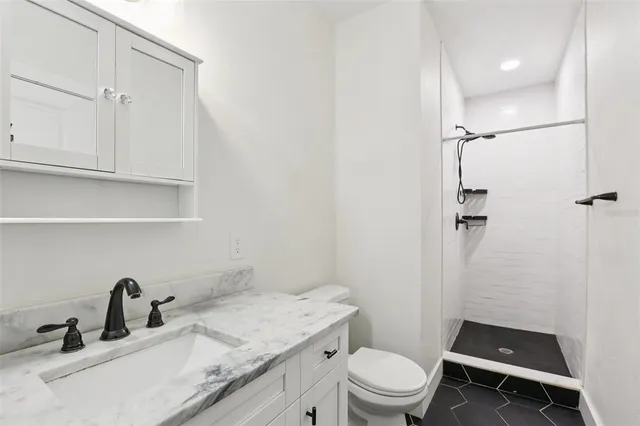 a view of a hallway with wooden cabinets