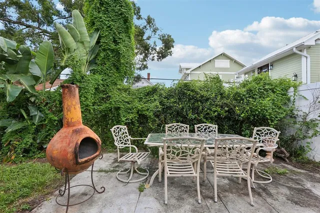 a view of a patio with table and chairs and potted plants