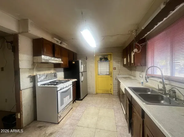 a view of a hallway with a refrigerator
