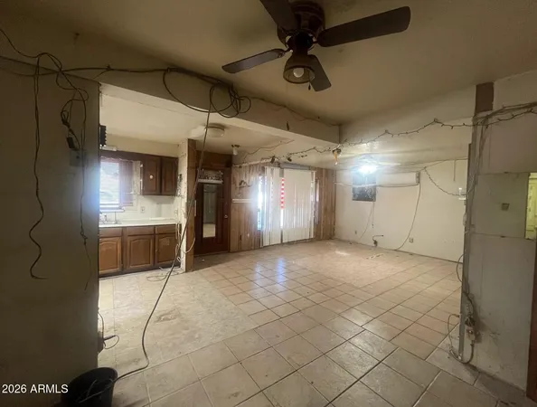 a view of a livingroom with furniture and a refrigerator