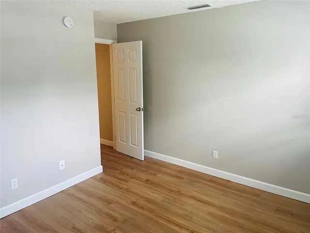 an empty room with wooden floor