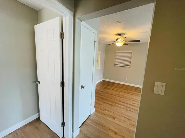a view of a room with wooden floor