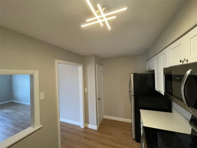 a kitchen with stainless steel appliances a refrigerator and a microwave