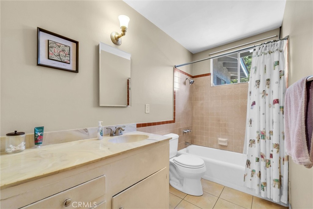 2551 Rome Avenue Anaheim, CA 92804 - Photo 18 of 27 a bathroom with a shower sink vanity mirror and toilet