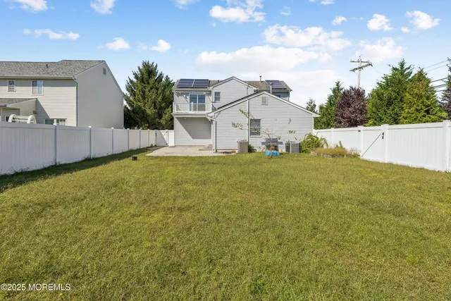 a view of a house with a yard and garage