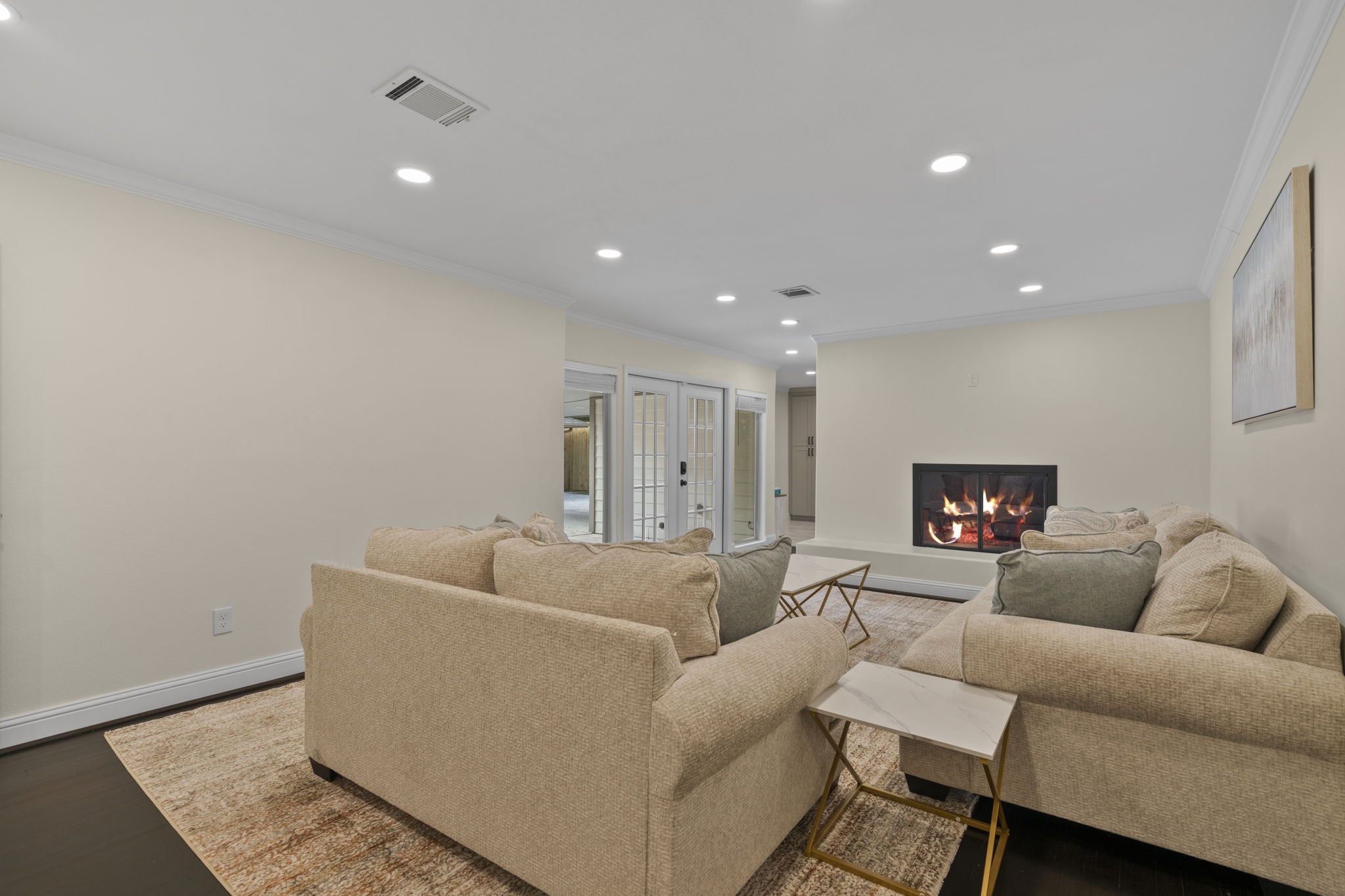 2402 Chimney Rock Road Houston, TX 77057 - Photo 22 of 36 Bright and inviting living area with recessed lighting, cozy fireplace, and elegant finishes.