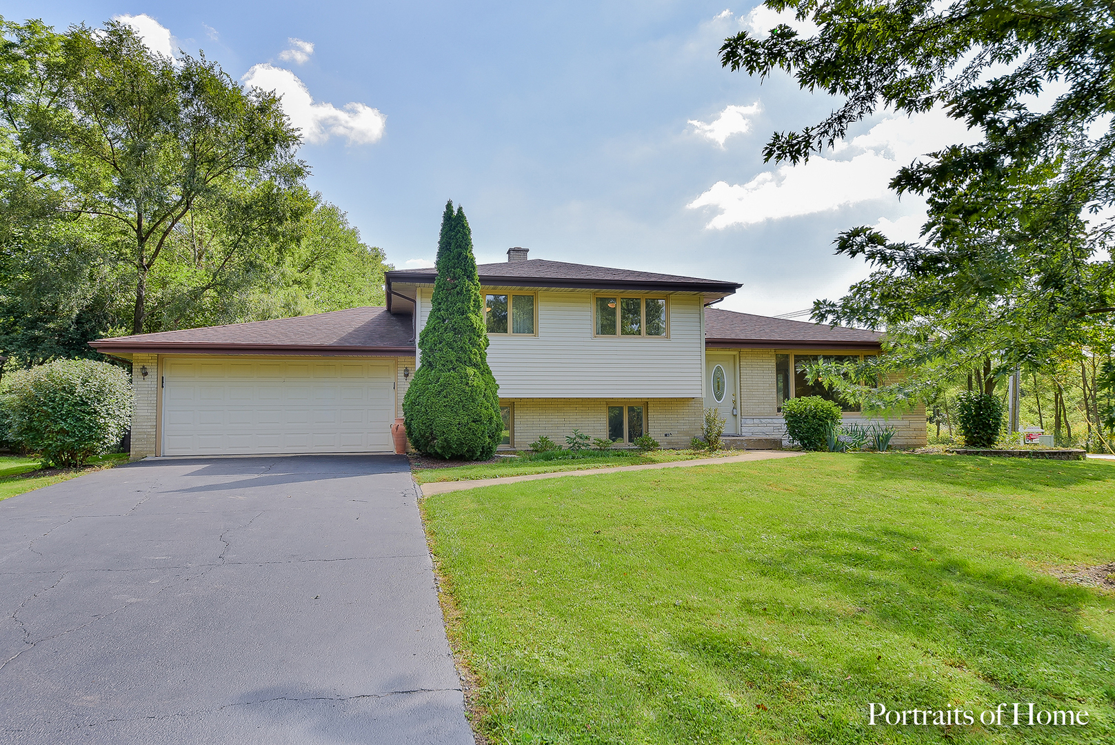 8645 Brookridge Road Downers Grove, IL 60516 - Photo 1 of 23 a front view of a house with a yard and garage