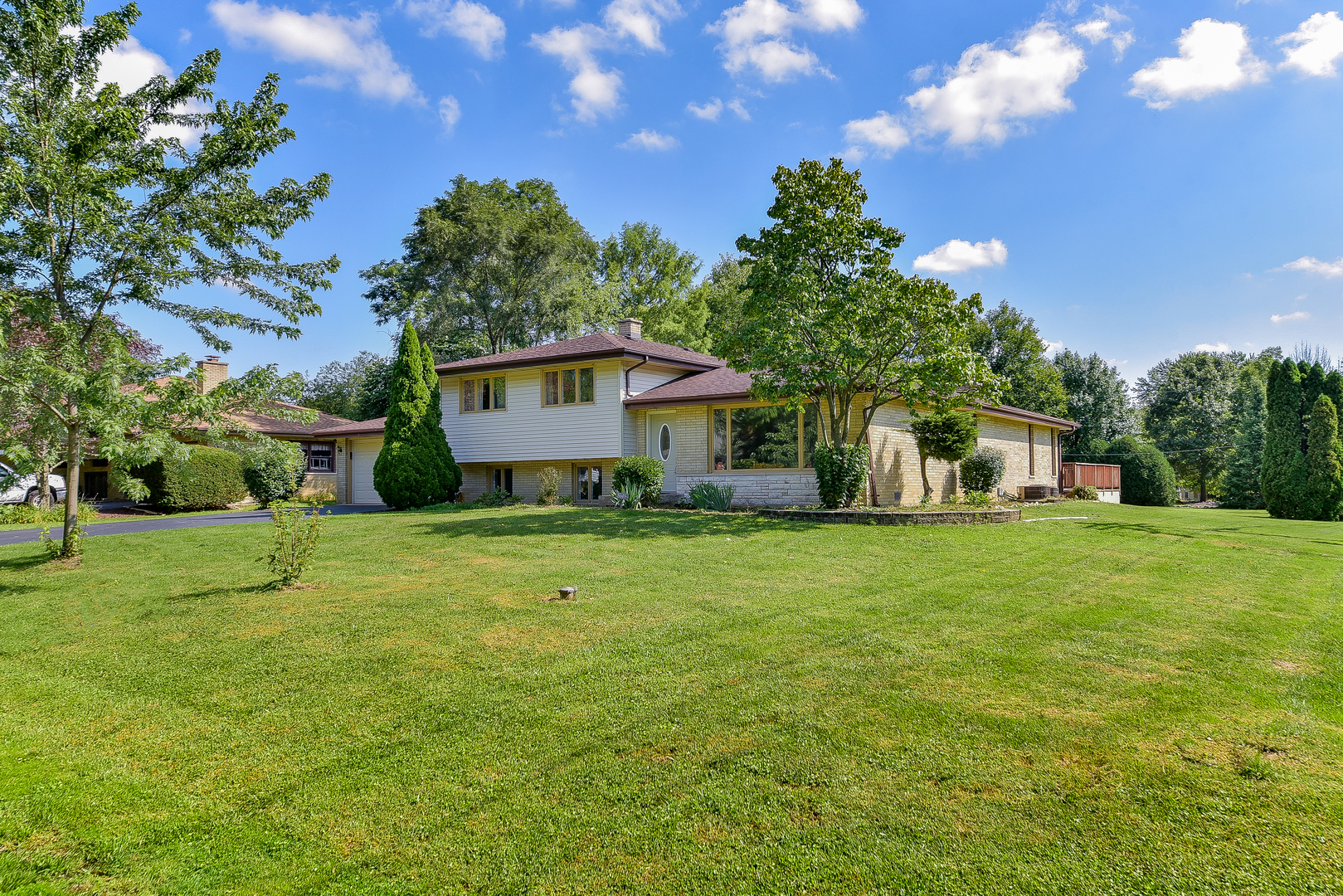 8645 Brookridge Road Downers Grove, IL 60516 - Photo 2 of 23 a front view of a house with garden