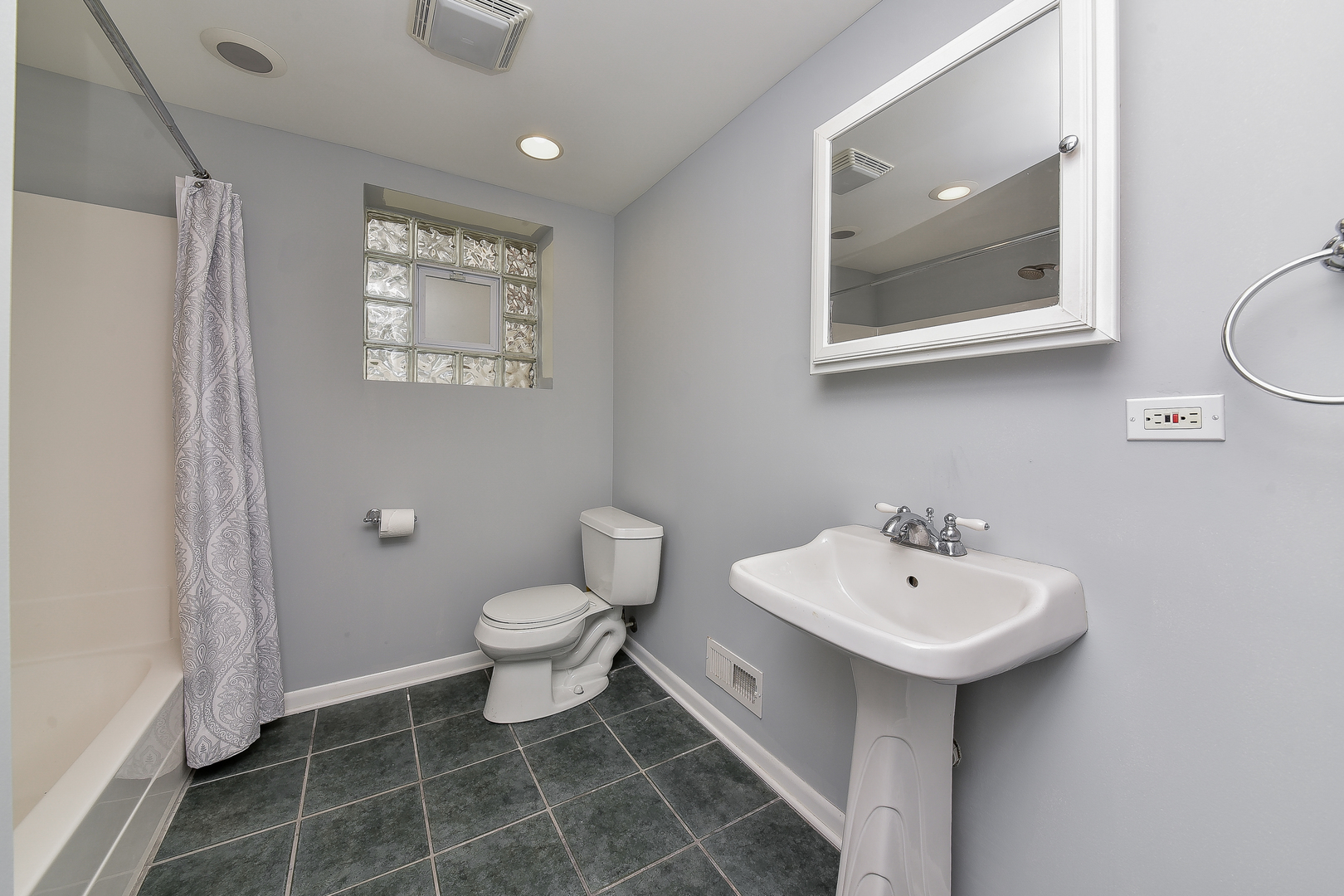 8645 Brookridge Road Downers Grove, IL 60516 - Photo 16 of 23 a bathroom with a sink toilet and a mirror