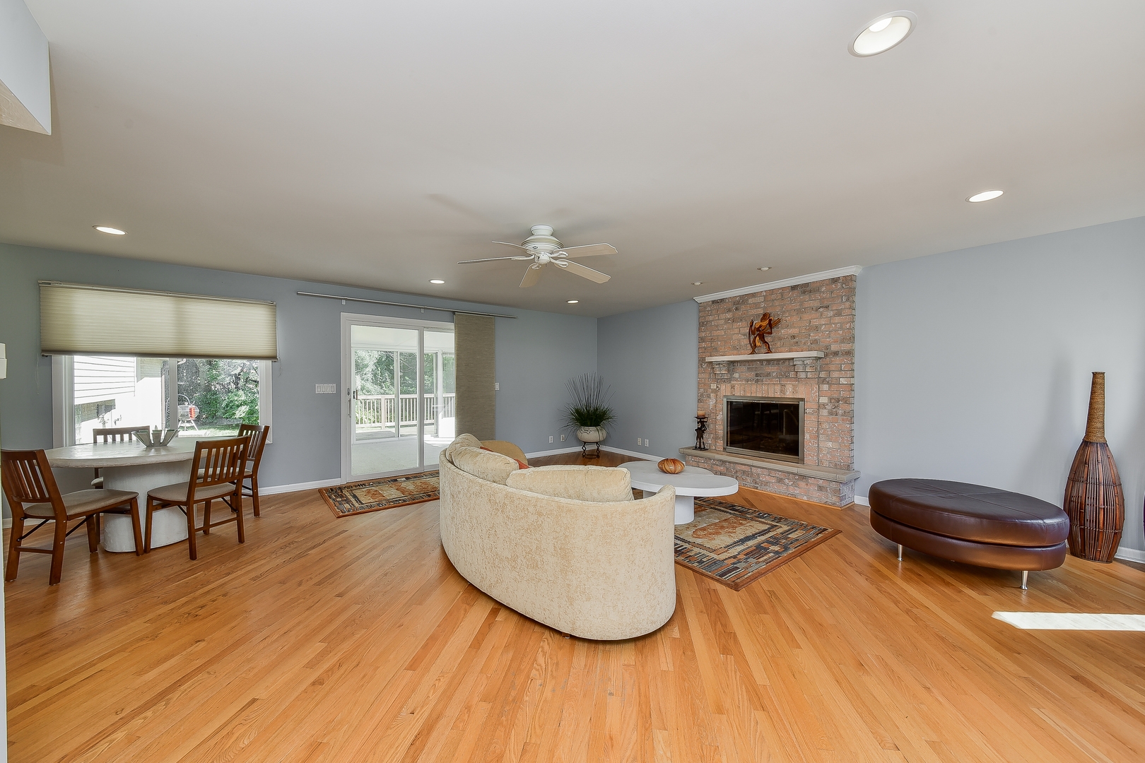 8645 Brookridge Road Downers Grove, IL 60516 - Photo 6 of 23 a living room with furniture a fireplace and a table