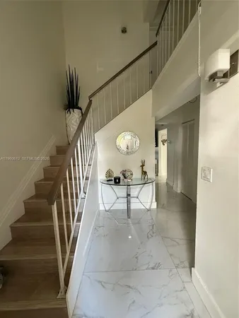 a view of entryway and hall with dining room