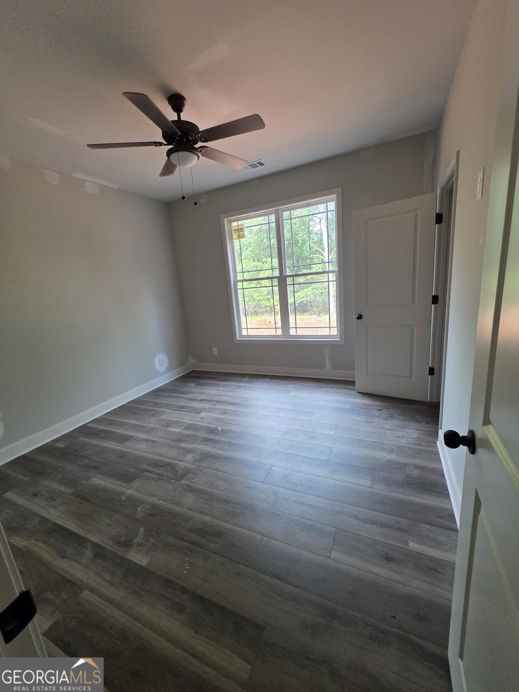 215 Panola Road Jackson, GA 30233 - Photo 11 of 16 a view of room with window and wooden floor
