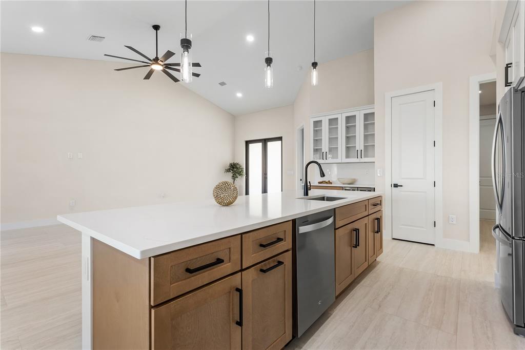 1711 Southwest 3rd Street Cape Coral, FL 33991 - Photo 12 of 45 a kitchen with stainless steel appliances a sink and cabinets