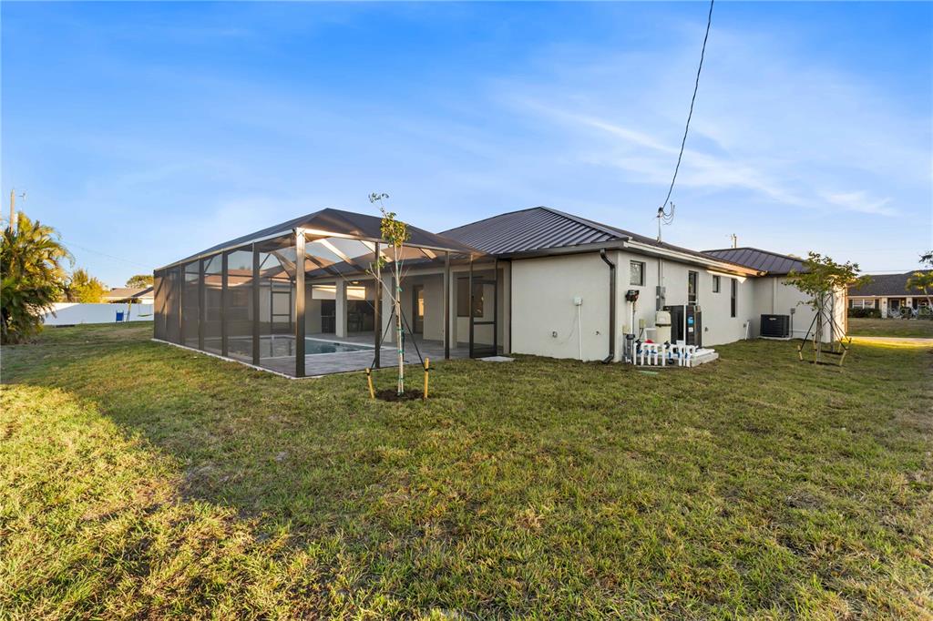 1711 Southwest 3rd Street Cape Coral, FL 33991 - Photo 19 of 45 a view of a house with a yard