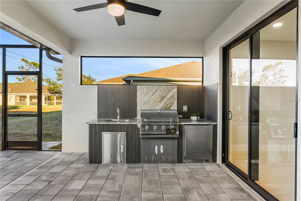 1711 Southwest 3rd Street Cape Coral, FL 33991 - Photo 24 of 45 a kitchen with stainless steel appliances granite countertop a refrigerator and a sink