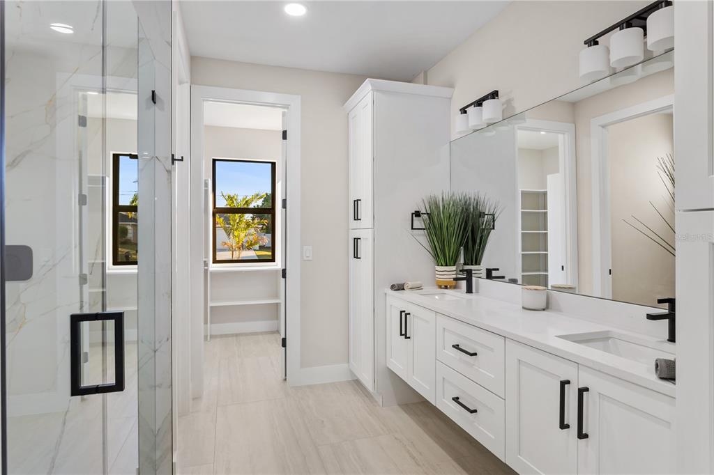 1711 Southwest 3rd Street Cape Coral, FL 33991 - Photo 27 of 45 a bathroom with a double vanity sink mirror and shower