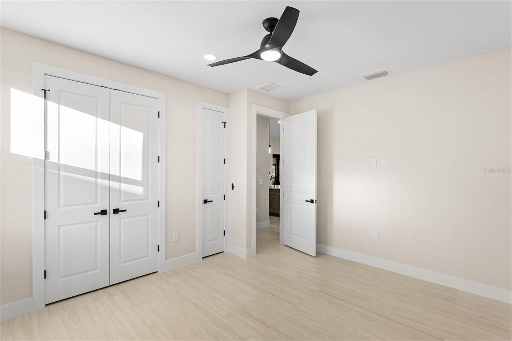 1711 Southwest 3rd Street Cape Coral, FL 33991 - Photo 33 of 45 a view of a livingroom with a chandelier fan and wooden floor