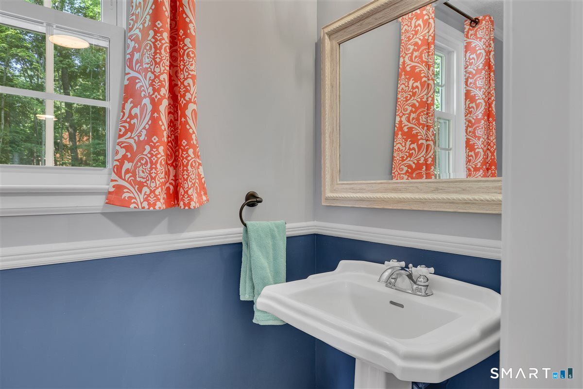 25 Silversmith Road Farmington, CT 06085 - Photo 15 of 33 a bathroom with a sink and a mirror
