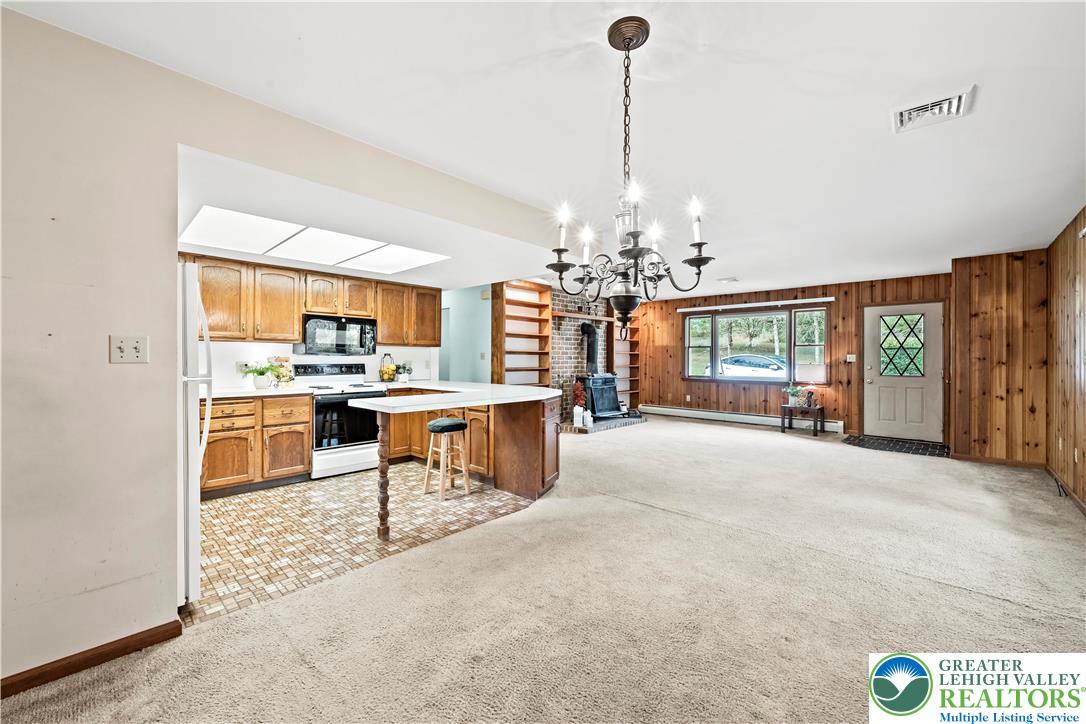 7509 Borman Road New Tripoli, PA 18066 - Photo 20 of 41 a view of a kitchen with dining table a chandelier and living room view