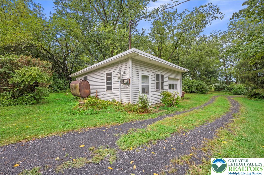 7509 Borman Road New Tripoli, PA 18066 - Photo 32 of 41 a view of a house with yard and a garden