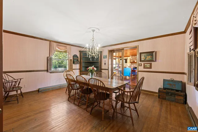 a view of a dining room with furniture and a chandelier