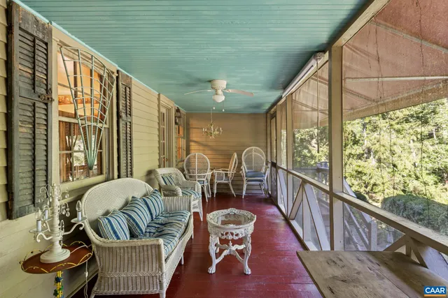 a view of a hallway with wooden floor and a bathroom