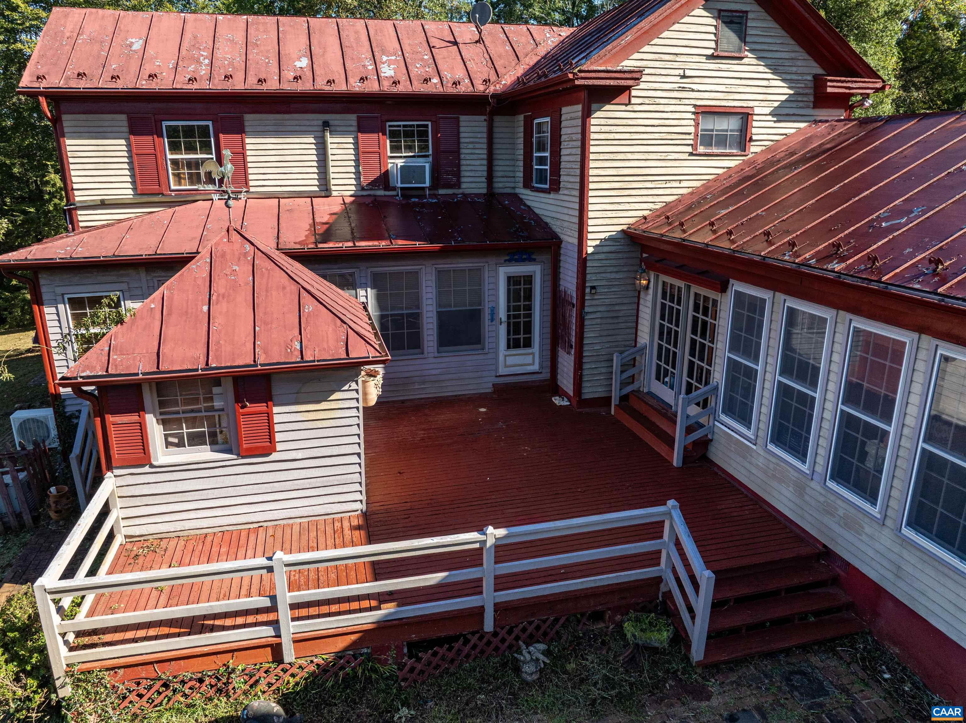 9290 Old Green Mountain Road Esmont, VA 22937 - Photo 42 of 54 a backyard of a house with wooden floor a barbeque oven and barbeque oven