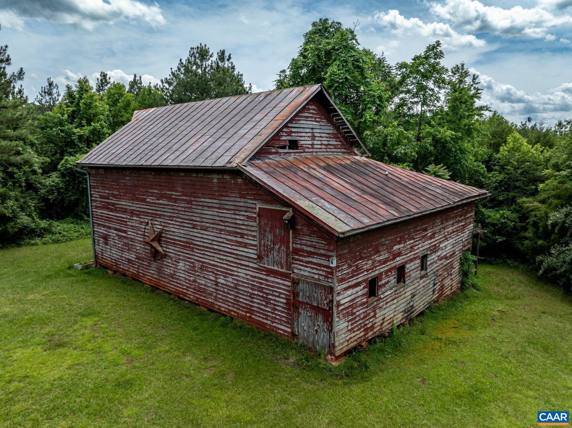 9290 Old Green Mountain Road Esmont, VA 22937 - Photo 50 of 54 a backyard of a house with a garden and deck