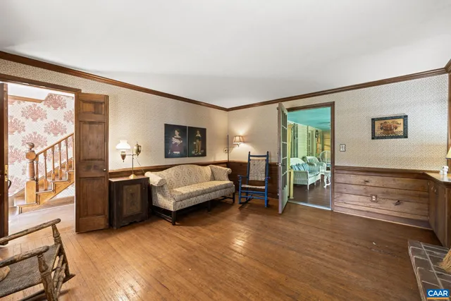 a view of a room with wooden floor and windows