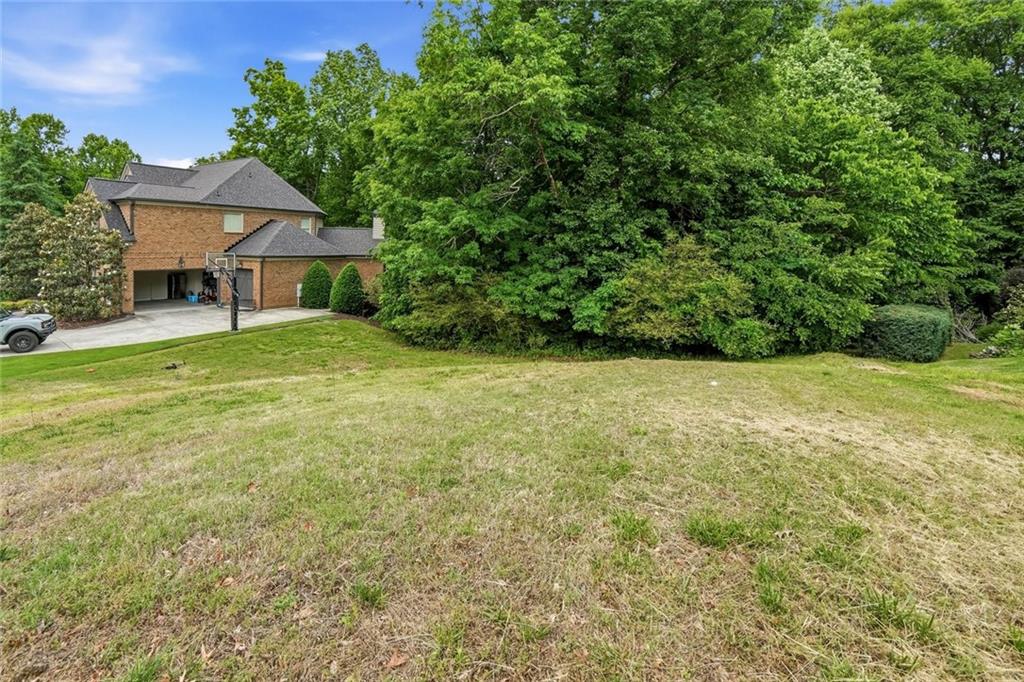 3820 Yaupon Way Cumming, GA 30040 - Photo 5 of 15 a front view of a house with yard and green space