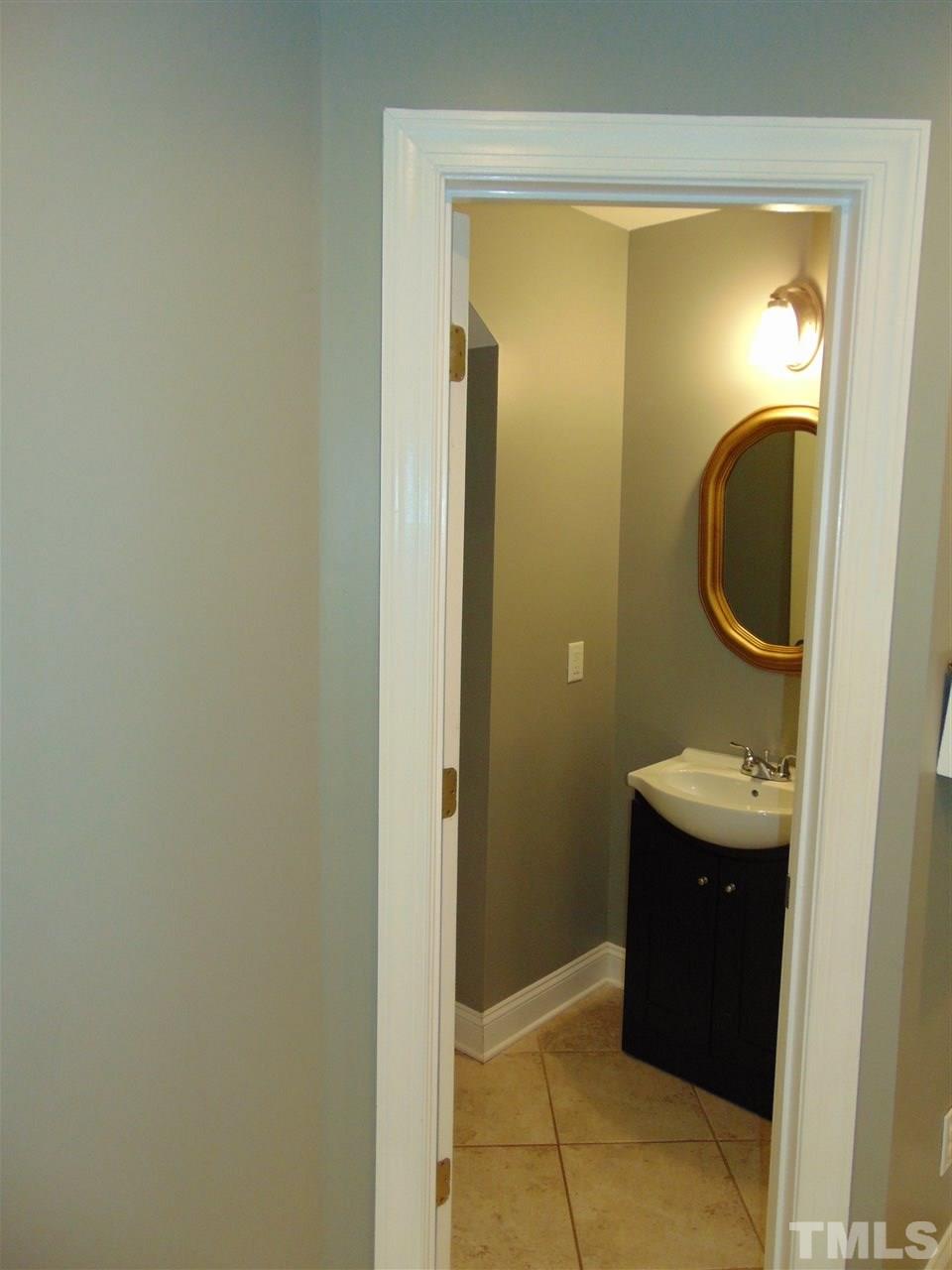 116 Crosspine Drive Raleigh, NC 27603 - Photo 11 of 21 a bathroom with a sink and a mirror