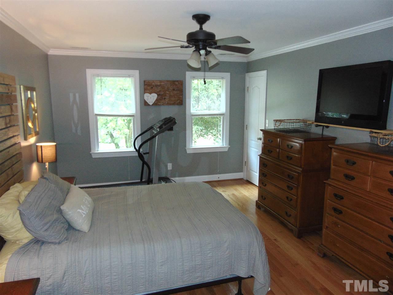 116 Crosspine Drive Raleigh, NC 27603 - Photo 13 of 21 a bedroom with furniture window and flat screen tv