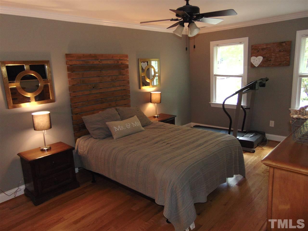 116 Crosspine Drive Raleigh, NC 27603 - Photo 14 of 21 a bedroom with a bed and a chandelier