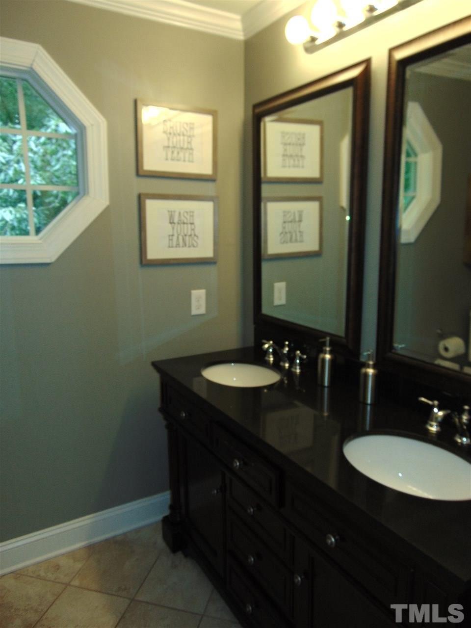 116 Crosspine Drive Raleigh, NC 27603 - Photo 15 of 21 a bathroom with a granite countertop sink a mirror and a window